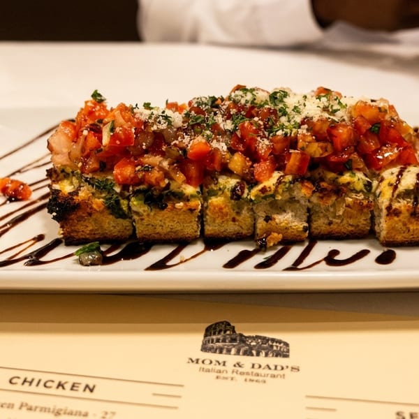 Mom & Dad's Italian Restaurant's bruschetta appetizer, topped with diced tomatoes, cheese, and balsamic glaze.